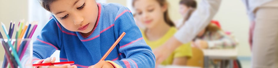 Close-up view of child studying in a classroom